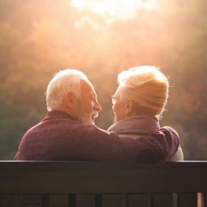 man and woman sitting on bench